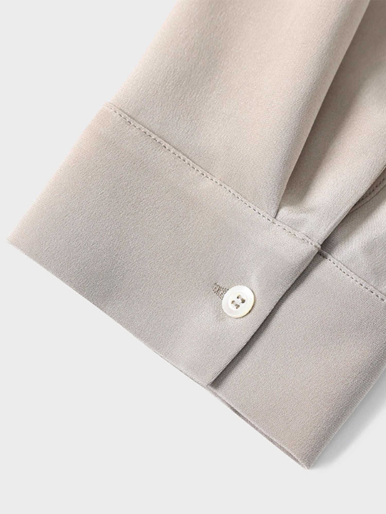 Close up of a buttoned cuff.