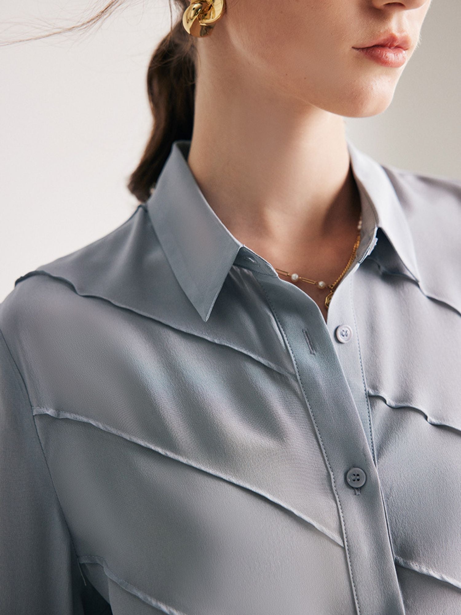 A close up of a woman with blue shirt