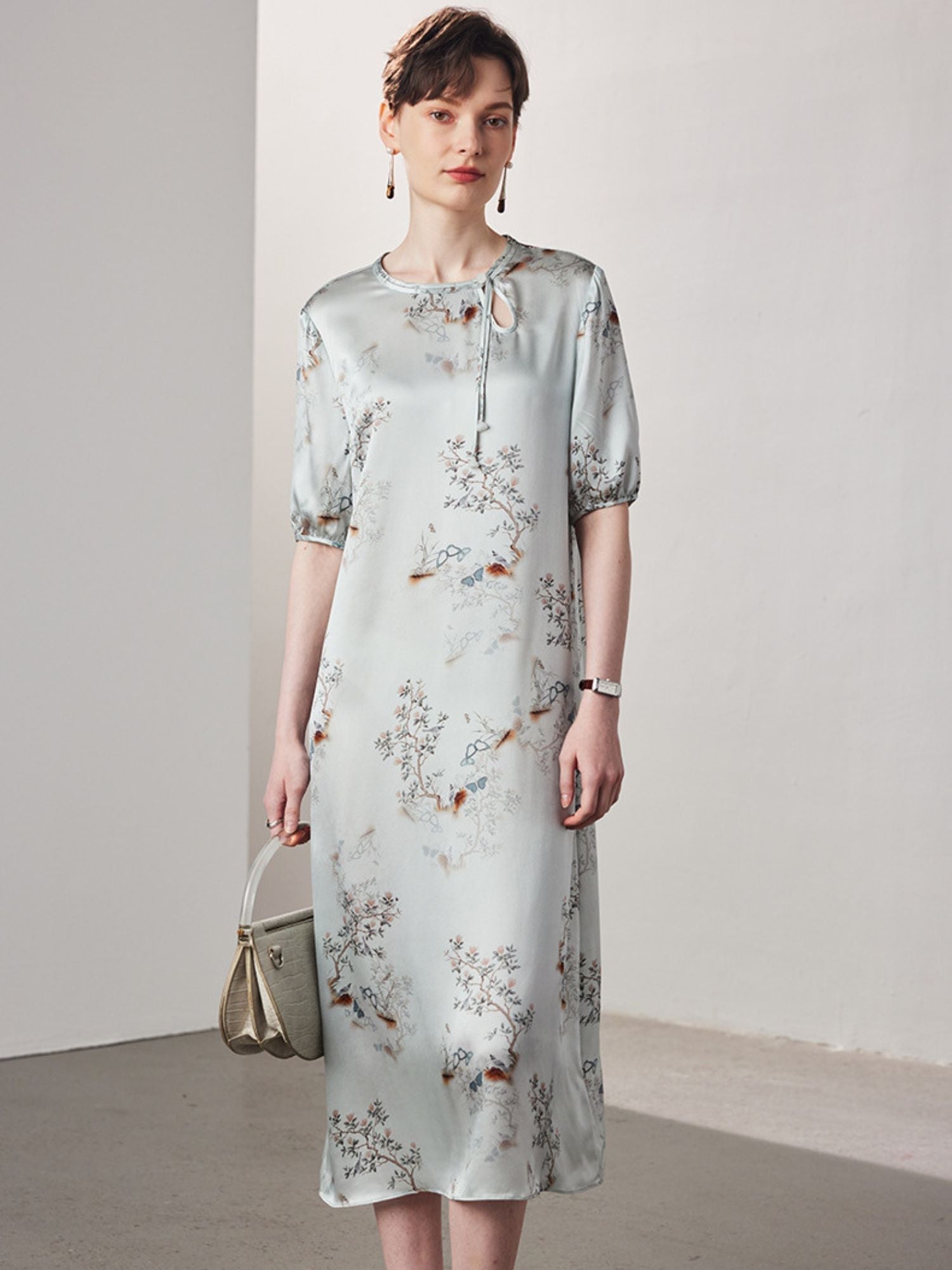 A woman wearing a light blue dress.