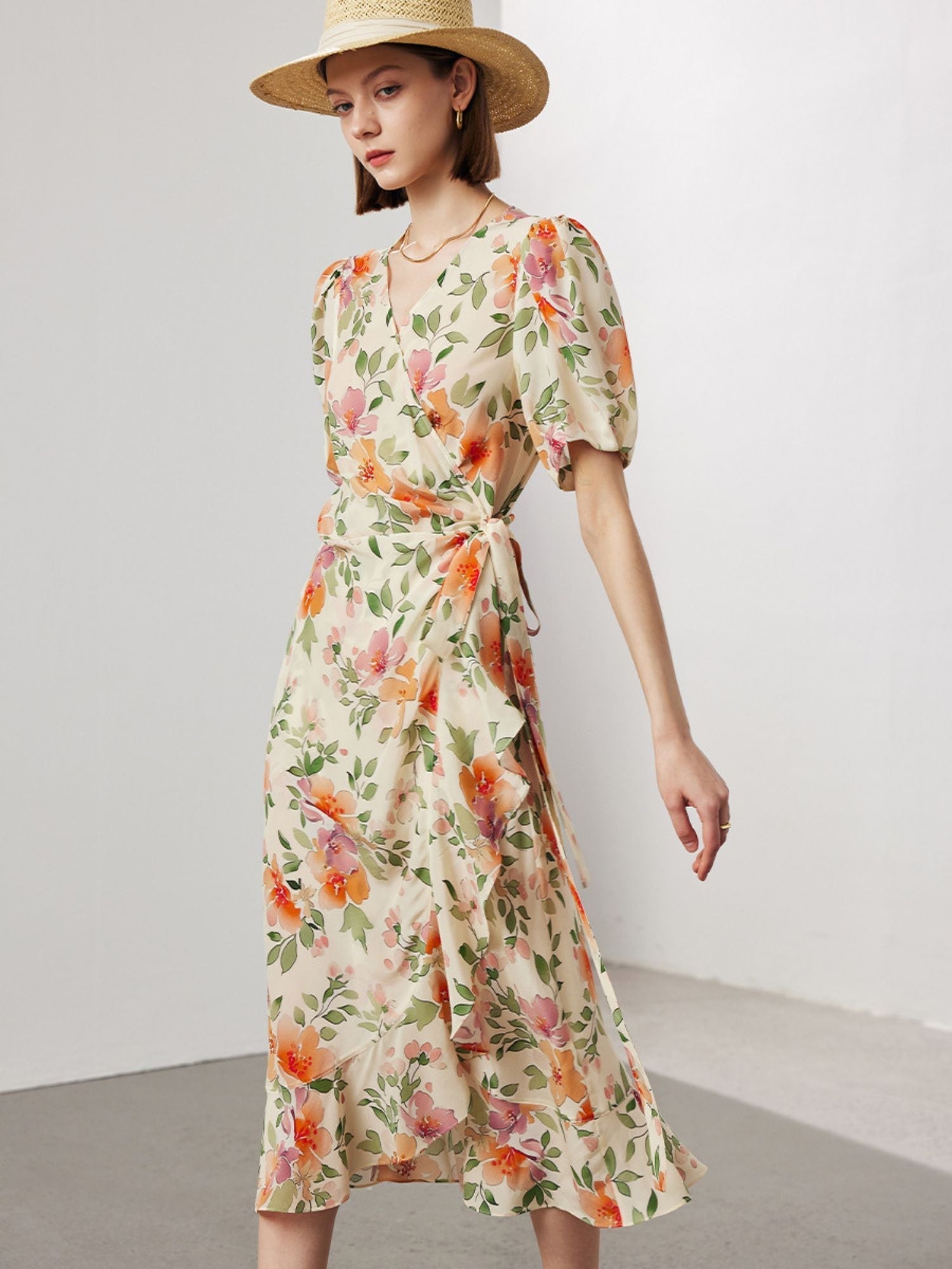 A woman wearing a wrap around floral dress.