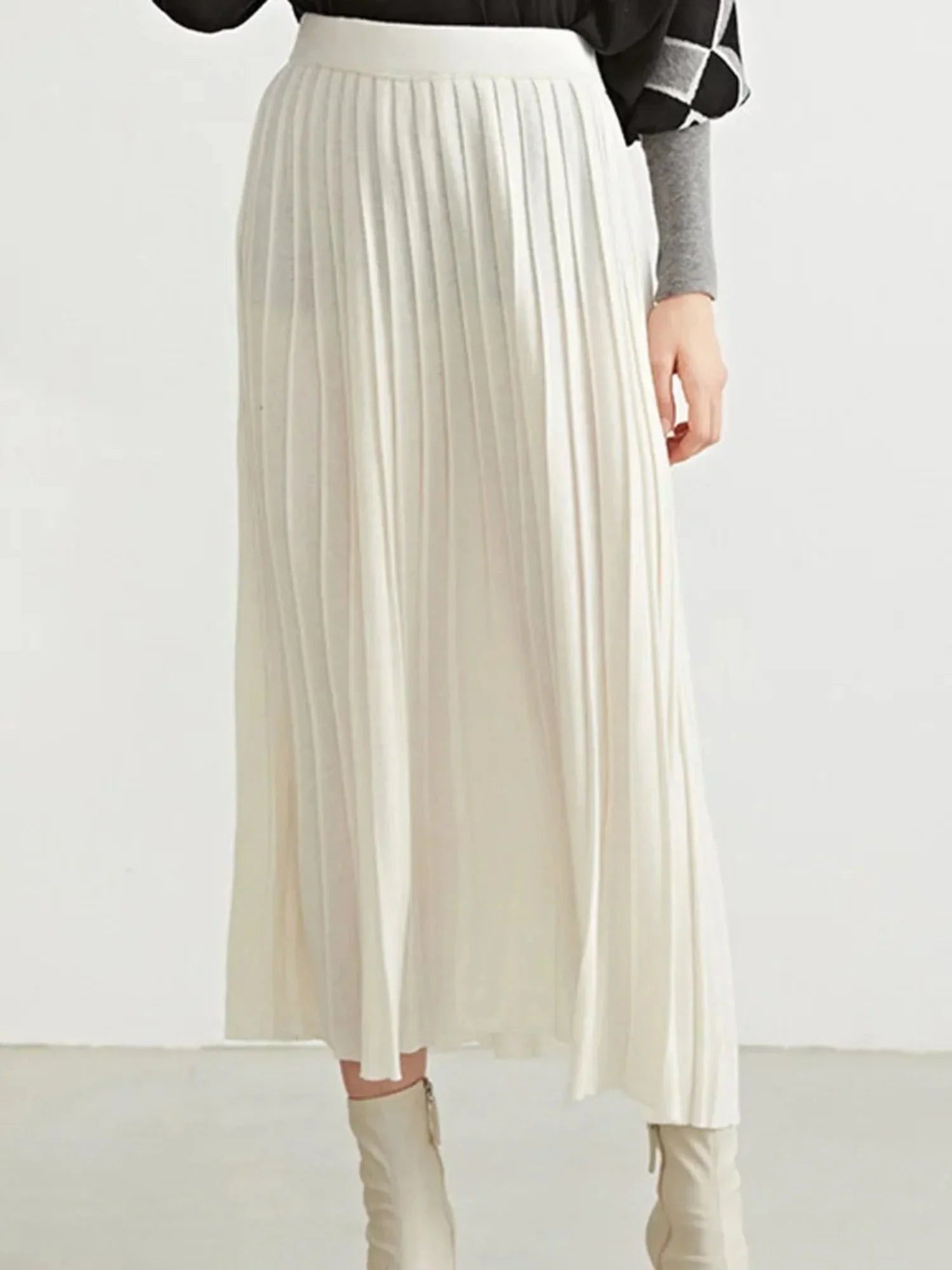 Close up of a white pleated skirt.