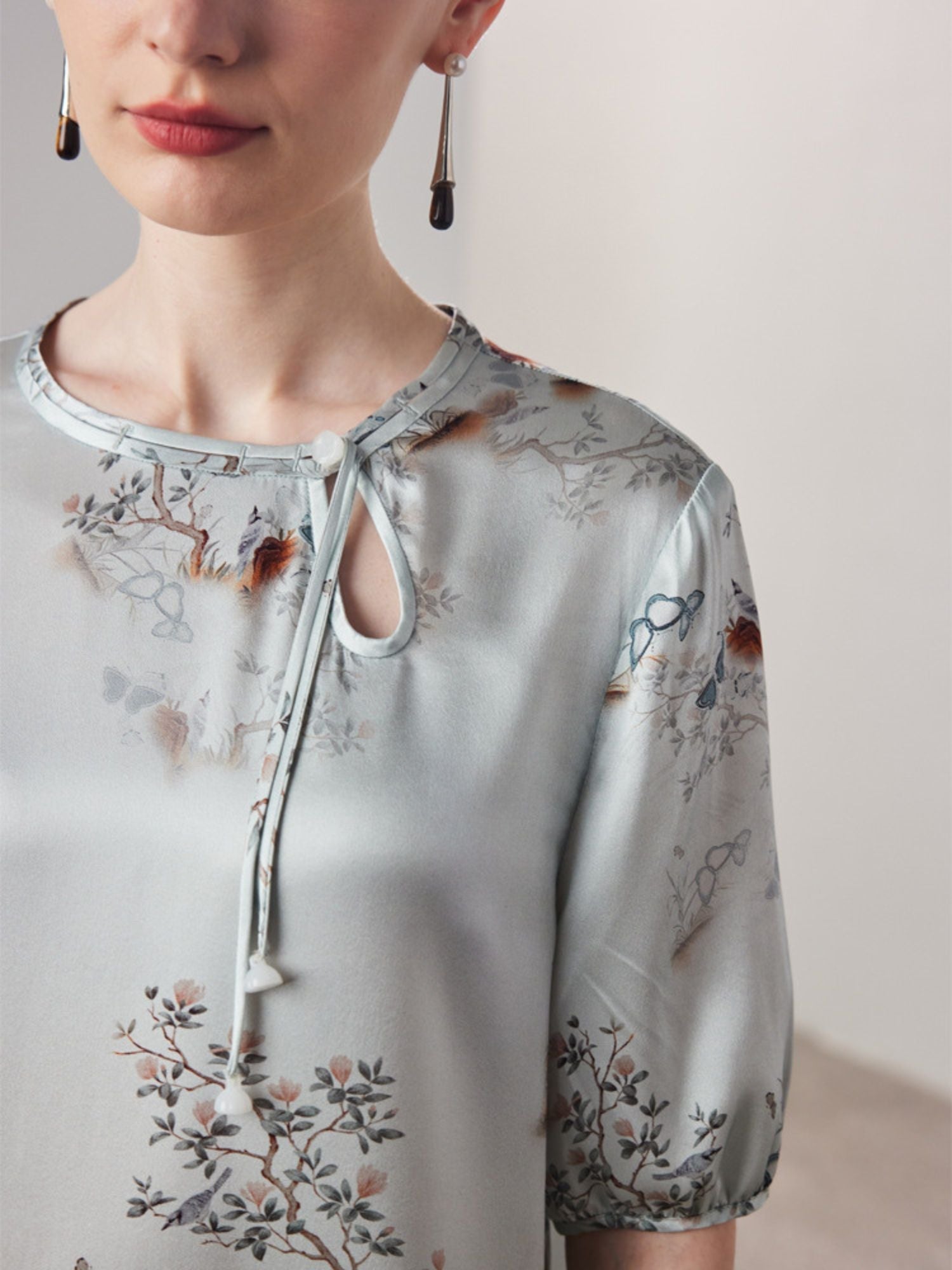 Close up of a woman wearing a dress with a keyhole detail.